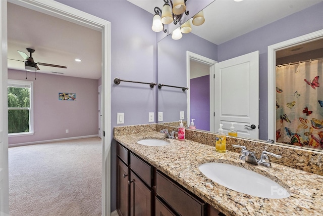 9825 Ardrey Woods Dr, Charlotte, NC 28277 - bathroom with baseboards, a sink, ceiling fan with notable chandelier, and double vanity
