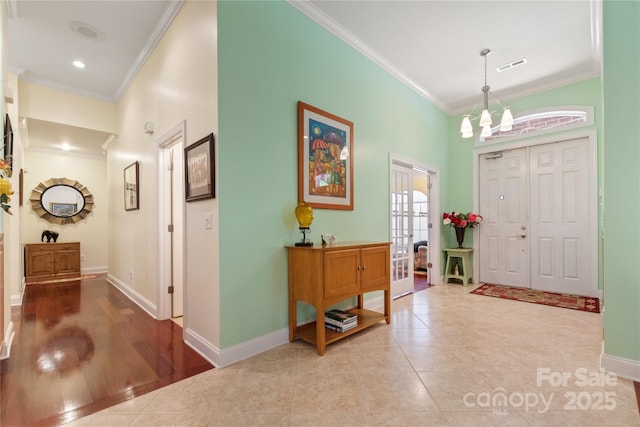 5342 Beacon Ridge Dr, Granite Falls, NC 28630 - foyer featuring crown molding, baseboards, a chandelier, tile patterned floors, and french doors