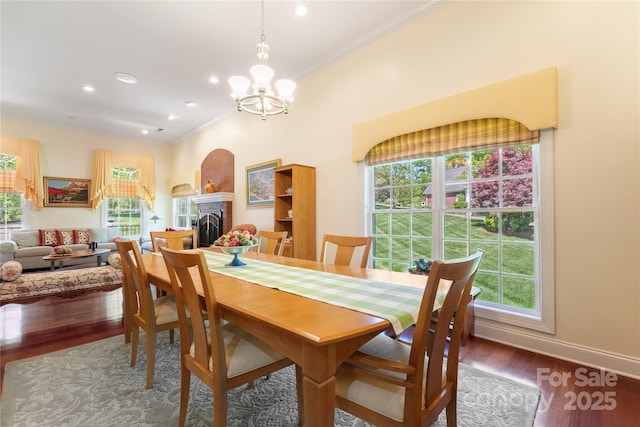 5342 Beacon Ridge Dr, Granite Falls, NC 28630 - dining area with crown molding, wood finished floors, plenty of natural light, a chandelier, and a fireplace