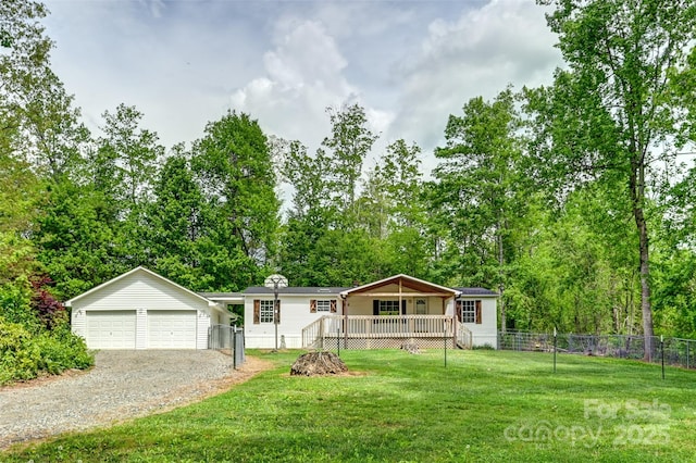 view of front of home with fence, an outbuilding, a front lawn, and a wooden deck