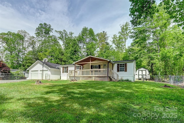 rear view of house featuring a fenced backyard, a storage unit, an outdoor structure, and a lawn