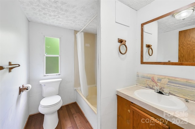 full bathroom featuring vanity, toilet, shower / bathtub combination with curtain, a textured ceiling, and hardwood / wood-style flooring