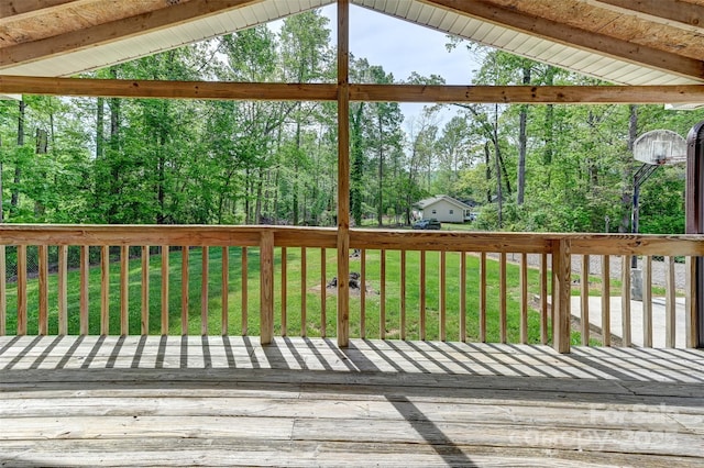 wooden terrace featuring a lawn