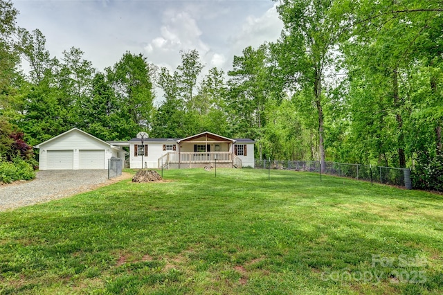 manufactured / mobile home featuring a front yard, fence, an outbuilding, and a deck