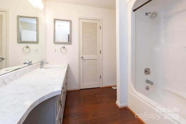 87 Marion Forest Rd Unit 8, Sylva, NC 28779 - bathroom with baseboards, shower / bathing tub combination, wood finished floors, and vanity