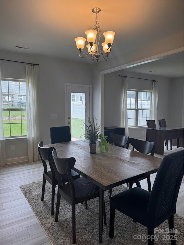 704 Robert Moses Dr Unit 121, Gastonia, NC 28056 - dining area with an inviting chandelier, plenty of natural light, light wood-style flooring, and visible vents