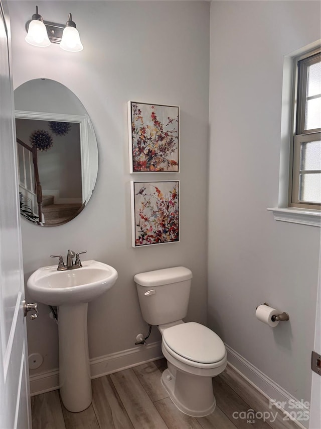 704 Robert Moses Dr Unit 121, Gastonia, NC 28056 - half bath with baseboards, a sink, wood finished floors, and toilet