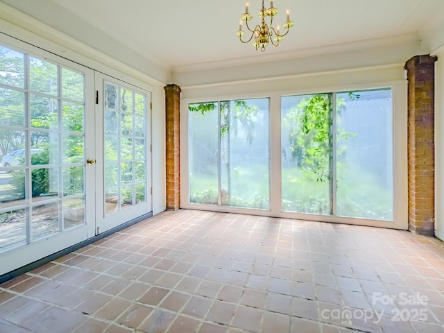 unfurnished sunroom with french doors, healthy amount of natural light, and tile patterned flooring
