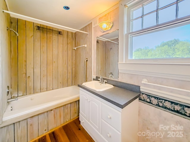full bath featuring vanity, bathtub / shower combination, and wood finished floors