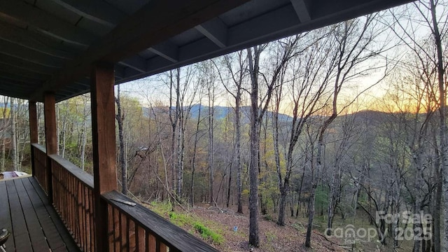 389 Lily Ln, Whittier, NC 28789 - deck at dusk with a view of trees and a mountain view