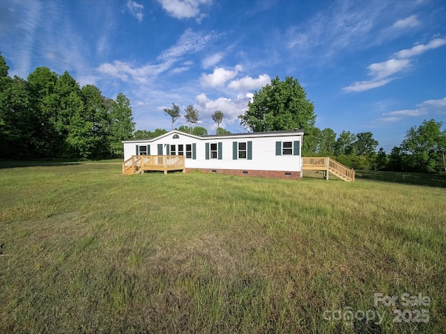 view of front of home featuring crawl space, a deck, and a front lawn