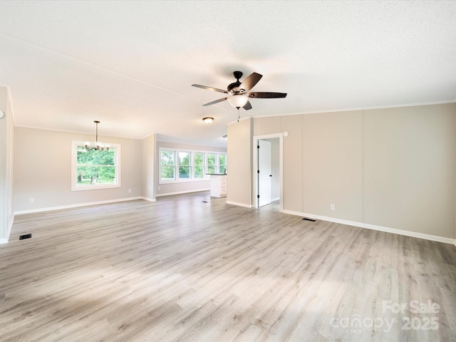 empty room with ceiling fan, a chandelier, light wood-type flooring, baseboards, and crown molding