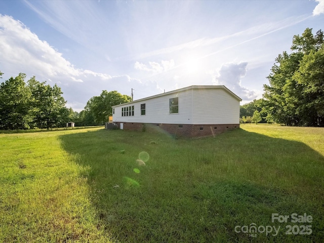 rear view of house featuring crawl space and a yard