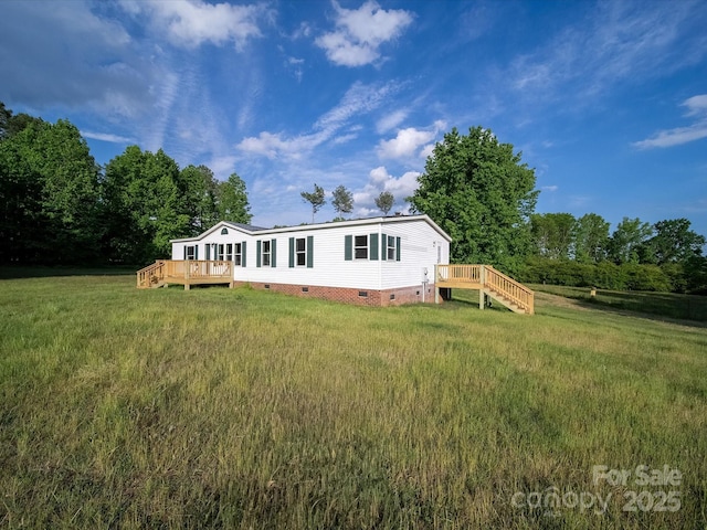 manufactured / mobile home with crawl space, a wooden deck, and a front yard