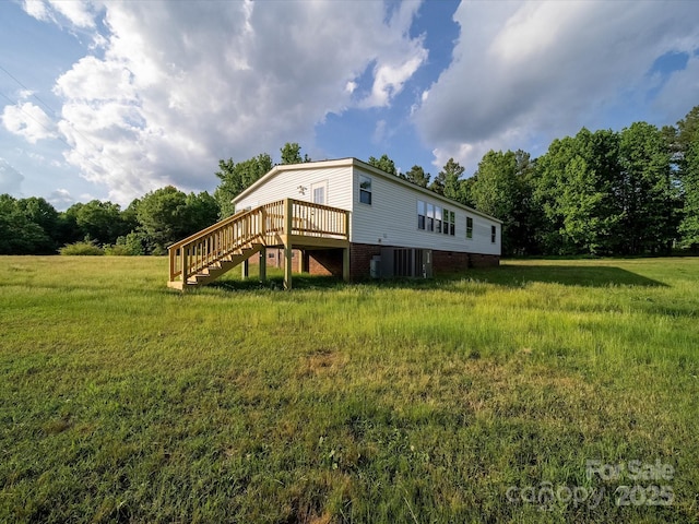 rear view of property with stairs and a deck