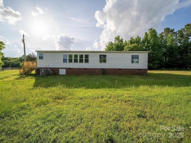 rear view of property featuring crawl space