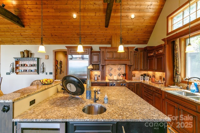 kitchen featuring wood ceiling, a sink, stainless steel appliances, lofted ceiling with beams, and a kitchen island with sink