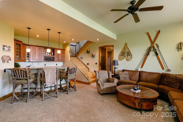 living room featuring stairs, indoor wet bar, recessed lighting, light carpet, and baseboards