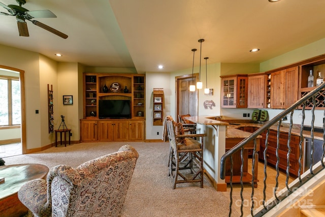 living area with ceiling fan, recessed lighting, and light colored carpet