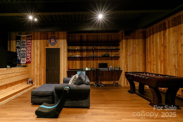 recreation room featuring wooden walls and wood finished floors
