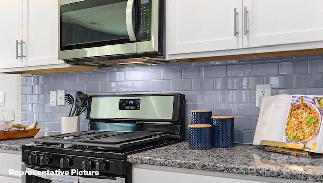 kitchen view of stainless steel appliances, backsplash, white cabinets, and stone counters