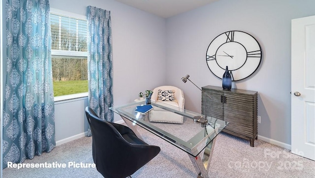 carpeted dining area featuring baseboards