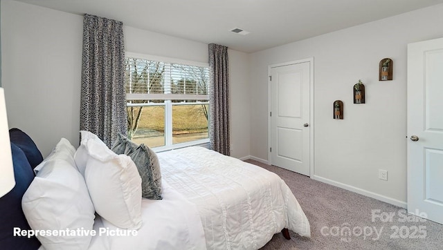 bedroom featuring carpet and baseboards