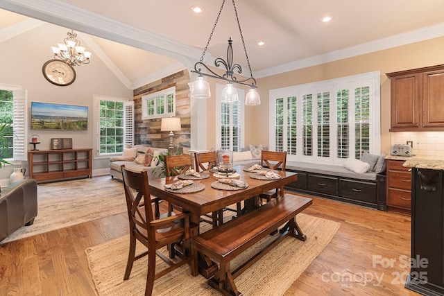 dining room featuring crown molding, an inviting chandelier, light wood finished floors, recessed lighting, and vaulted ceiling