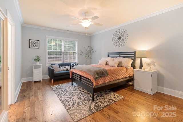 bedroom with baseboards, ornamental molding, and light wood finished floors