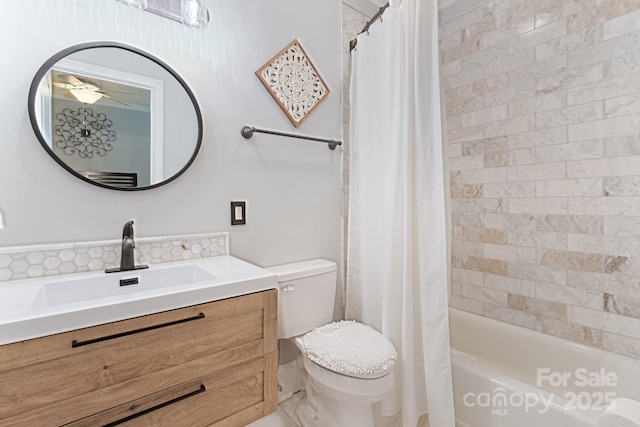 full bathroom featuring vanity, a ceiling fan, shower / bath combo with shower curtain, and toilet