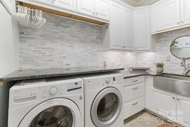 clothes washing area with a sink, separate washer and dryer, light tile patterned floors, and cabinet space