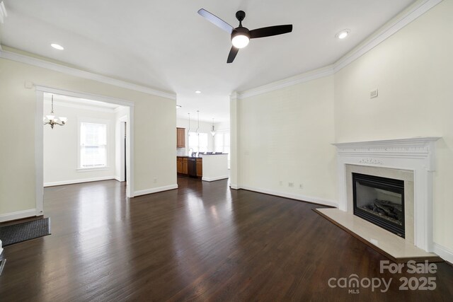 1855 Second Baxter Xing, Fort Mill, SC 29708 - unfurnished living room with a chandelier, a glass covered fireplace, ornamental molding, dark wood-style flooring, and a ceiling fan
