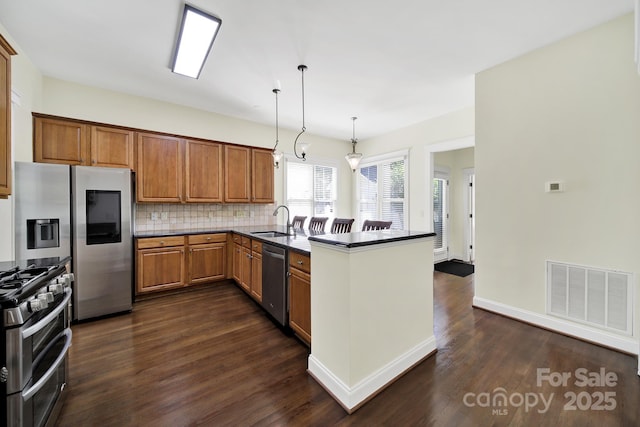 1855 Second Baxter Xing, Fort Mill, SC 29708 - kitchen with appliances with stainless steel finishes, a sink, a peninsula, and dark wood-style flooring