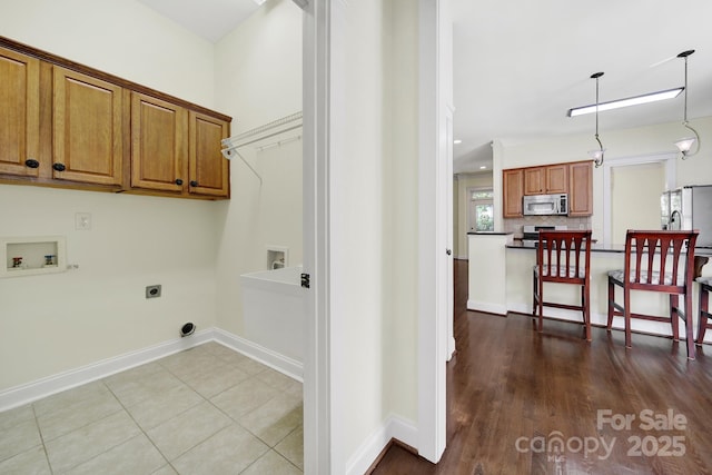 1855 Second Baxter Xing, Fort Mill, SC 29708 - washroom with washer hookup, hookup for an electric dryer, cabinet space, baseboards, and wood finished floors