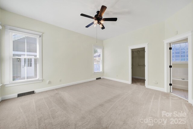 1855 Second Baxter Xing, Fort Mill, SC 29708 - unfurnished bedroom featuring carpet floors, baseboards, a walk in closet, connected bathroom, and a ceiling fan
