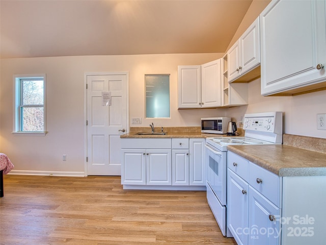 kitchen featuring a sink, stainless steel microwave, white cabinetry, white range with electric cooktop, and light wood-style floors