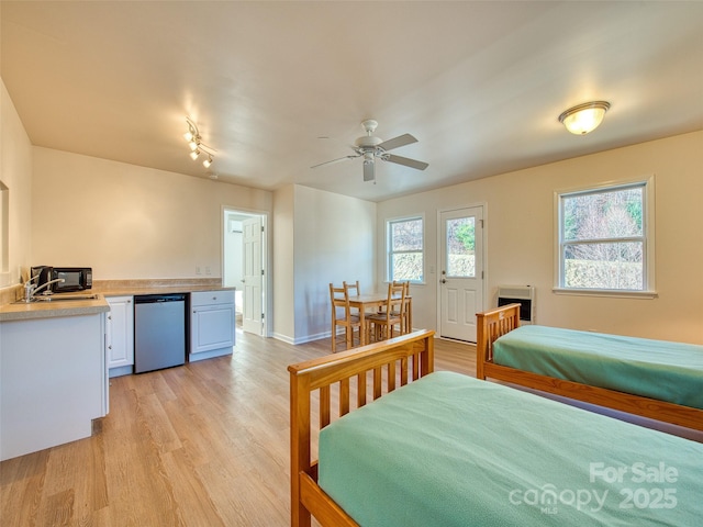 bedroom with light wood-style flooring and a sink