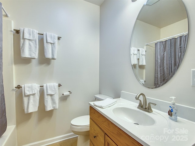full bath with toilet, baseboards, and vanity