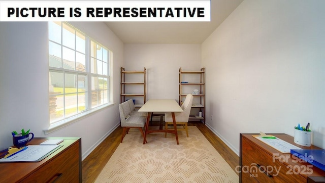 interior space featuring baseboards and wood finished floors