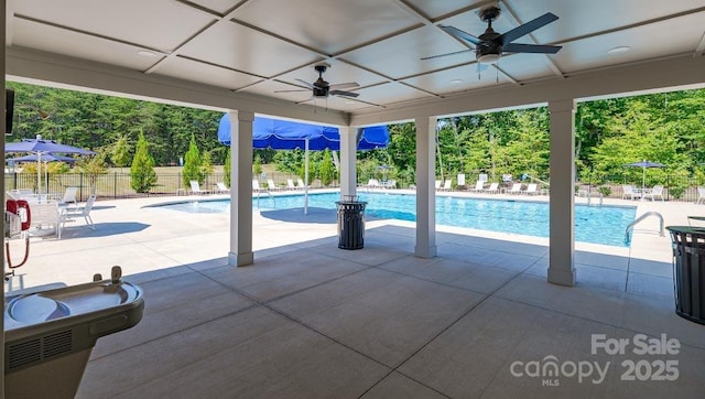 pool featuring a patio, ceiling fan, and fence