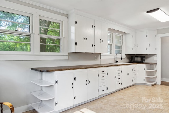 130 Casper Rd, Gold Hill, NC 28071 - kitchen with open shelves, black microwave, plenty of natural light, and a sink