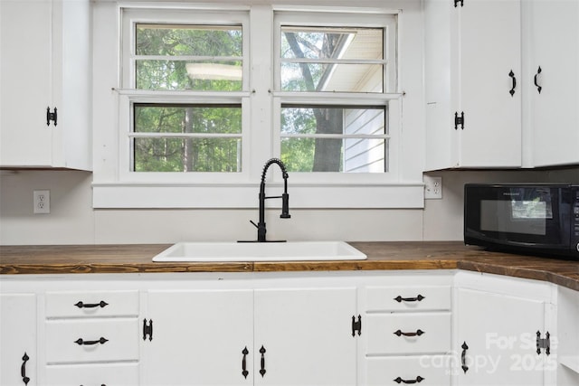 130 Casper Rd, Gold Hill, NC 28071 - kitchen featuring butcher block countertops, a sink, white cabinets, and black microwave