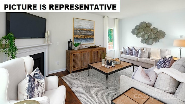 living area with wood finished floors, a fireplace, and baseboards