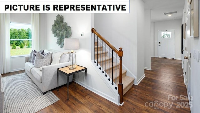 stairway with wood finished floors, baseboards, and recessed lighting