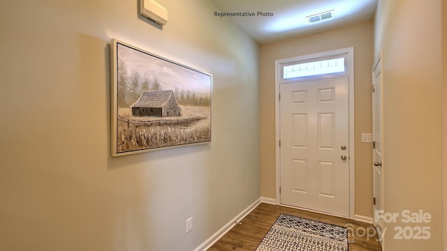 entryway featuring visible vents, baseboards, and wood finished floors