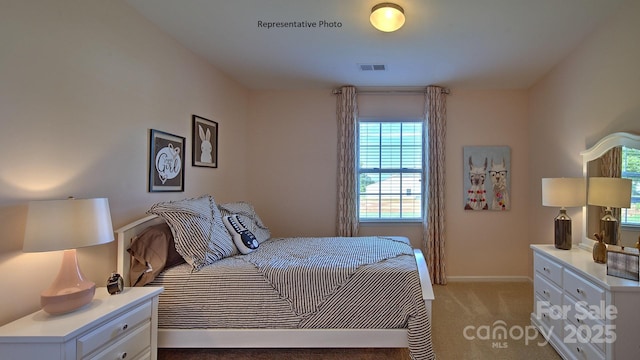 bedroom featuring baseboards, visible vents, and light carpet