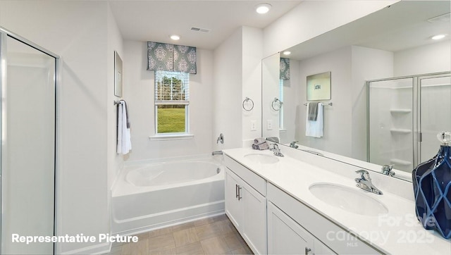full bathroom with a stall shower, a bath, double vanity, and recessed lighting