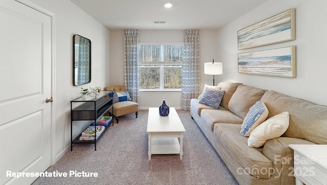 living room featuring carpet, baseboards, and recessed lighting