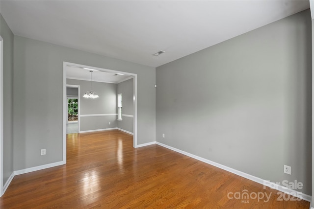 9321 Bradstreet Commons Way, Charlotte, NC 28215 - unfurnished room with a chandelier, wood finished floors, and baseboards