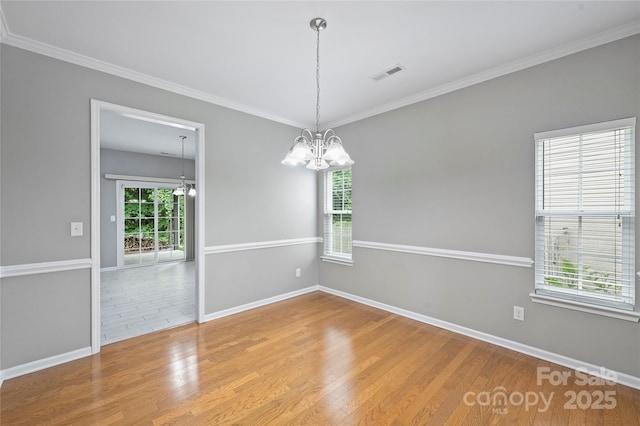 9321 Bradstreet Commons Way, Charlotte, NC 28215 - unfurnished room featuring a chandelier, wood finished floors, baseboards, and crown molding
